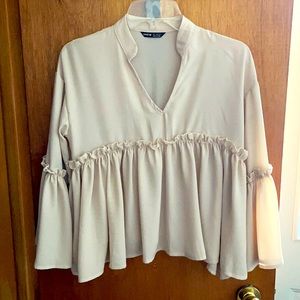 Cream colored loose fitting blouse